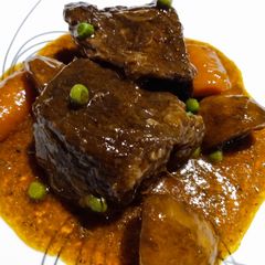 A picture of Slow-braised beef short ribs and gravy.