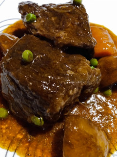 A picture of Slow-braised beef short ribs and gravy.