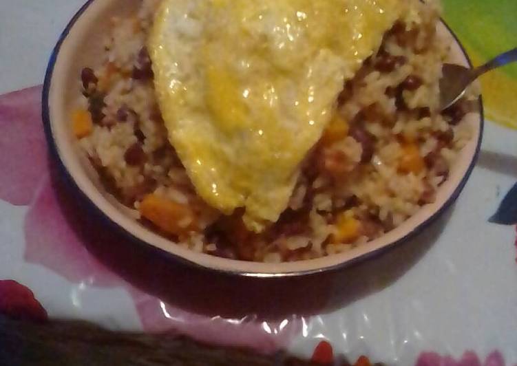 Rice and beans served with filed egg