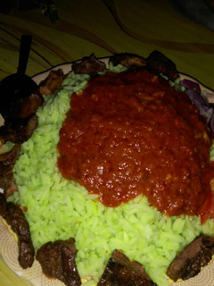 A picture of Color rice and stew with tsirai.