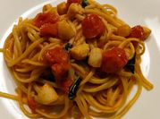 A picture of scallops with basil