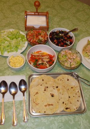 A picture of Taco Bar with a Variety of Fillings: Black Beans, Shrimp, Albacore.