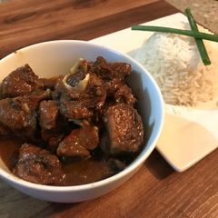 A picture of Caribbean curry goat and Rice.