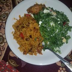 Jollof Rice With lettuce salad A picture of Jollof Rice With lettuce salad.