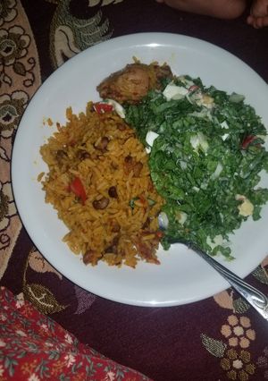 A picture of Jollof Rice With lettuce salad.