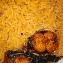 A picture of Jollof rice with fried fish.