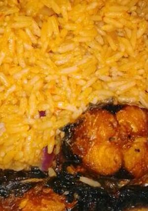 A picture of Jollof rice with fried fish.