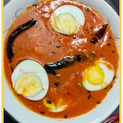 A picture of Tomato egg curry.