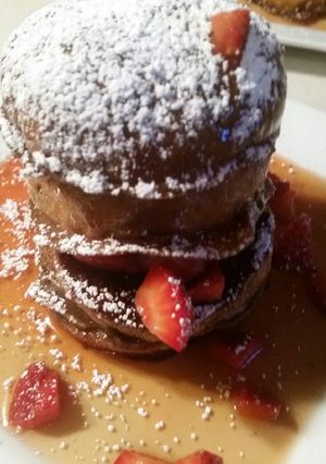A picture of Chocolate Pannetone French Toast w/ Mascerated Strawberries.