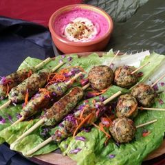 A picture of Chicken Kabab with Beetroot hummus.