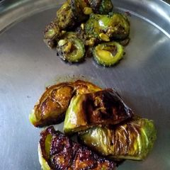 A picture of Brinjal fry and bitter gourd sliced brinjal fry.