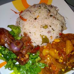 A picture of Vegetable rice with irish sauce and peppered chicken.
