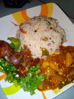 A picture of Vegetable rice with irish sauce and peppered chicken.