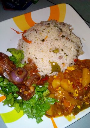 A picture of Vegetable rice with irish sauce and peppered chicken.
