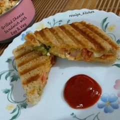 A picture of Grilled Cheese Sandwich with Egg & Vegetables.