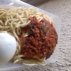 A picture of Spagetti with boiled egg and tomatoes stew.