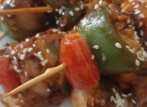 A picture of Chicken satay with spicy garlic sauce.