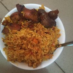 Party jollof with fried chicken A picture of Party jollof with fried chicken.