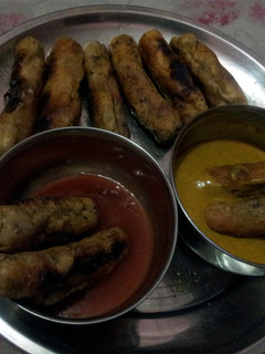 A picture of golden brown saucages in lemon mustard and taco sauce.