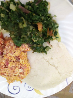 A picture of Ugali served with srambled egg and some vegetables.