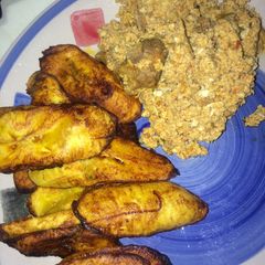 A picture of Fried Plantain/Dodo with Egg and Goat meat sauce.