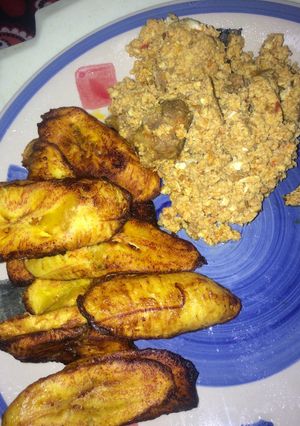 A picture of Fried Plantain/Dodo with Egg and Goat meat sauce.
