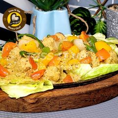 A picture of Sizzler Chicken Makhni Malai Boti Restaurant Style With Sauted Veggies.