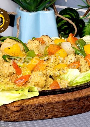 A picture of Sizzler Chicken Makhni Malai Boti Restaurant Style With Sauted Veggies.