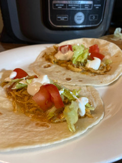 A picture of Slow cooker queso chicken tacos.