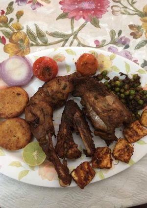 A picture of Tandoori chicken in microwave and in a pan.