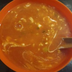 A picture of Chicken with tomato puree soup.