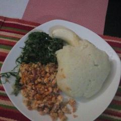 A picture of Eggs,Ugali with Fried kales.