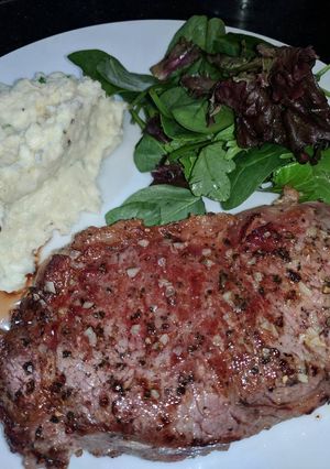 A picture of Pan Fried Porterhouse Steak w/ Garlic Butter and Rosemary.