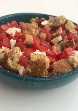 A picture of Dakos - tomato, feta and bread.