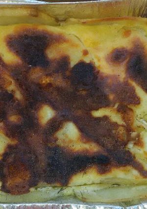 Una foto de Papas al queso crema en la parrilla