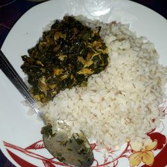 A picture of Ofada rice with vegetable soup.