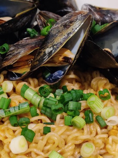 A picture of Spicy Peanut Butter Ramen with Mussels.