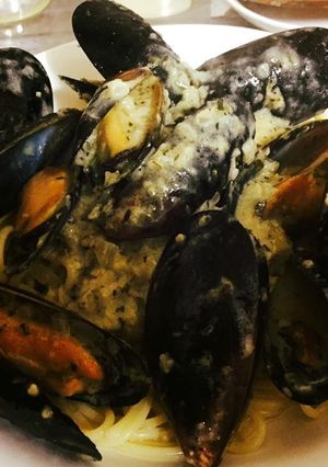 A picture of Pasta with Mussels in a garlic butter cream sauce.
