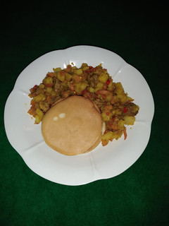 A picture of Pancakes and beef potato sauce.