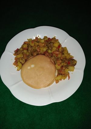 A picture of Pancakes and beef potato sauce.