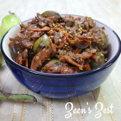 A picture of Chugur Baingan or Tender Tamarind Leaves with Eggplants and dry Prawns.