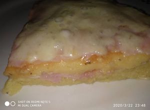 Una foto de Polenta rellena a la pizza