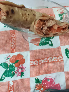 A picture of Orange chicken tikka paratha roll.