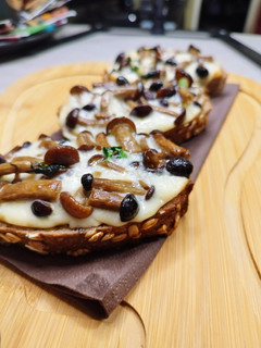 A picture of Bruschetta with Pioppini Mushrooms🍄🥖🧀.
