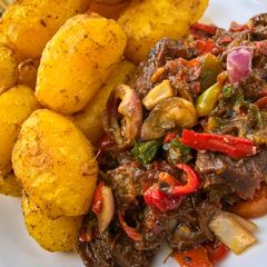 A picture of Baked irish potatoes and beef sauce.