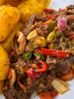 A picture of Baked irish potatoes and beef sauce.