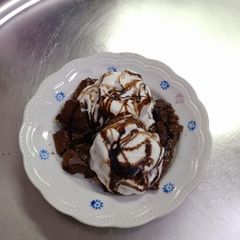 A picture of Delicious custard chocolate dessert with ice cream.