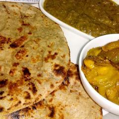 A picture of Hara palak ka saag, bajra roti with kanda karela.