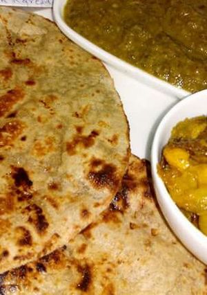 A picture of Hara palak ka saag, bajra roti with kanda karela.