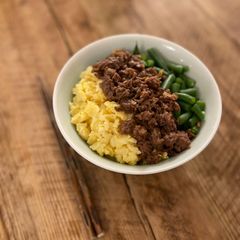 A picture of 🍚 Tricolor Donburi - Japanese bowl of rice with minced meat, eggs and green vegetable.